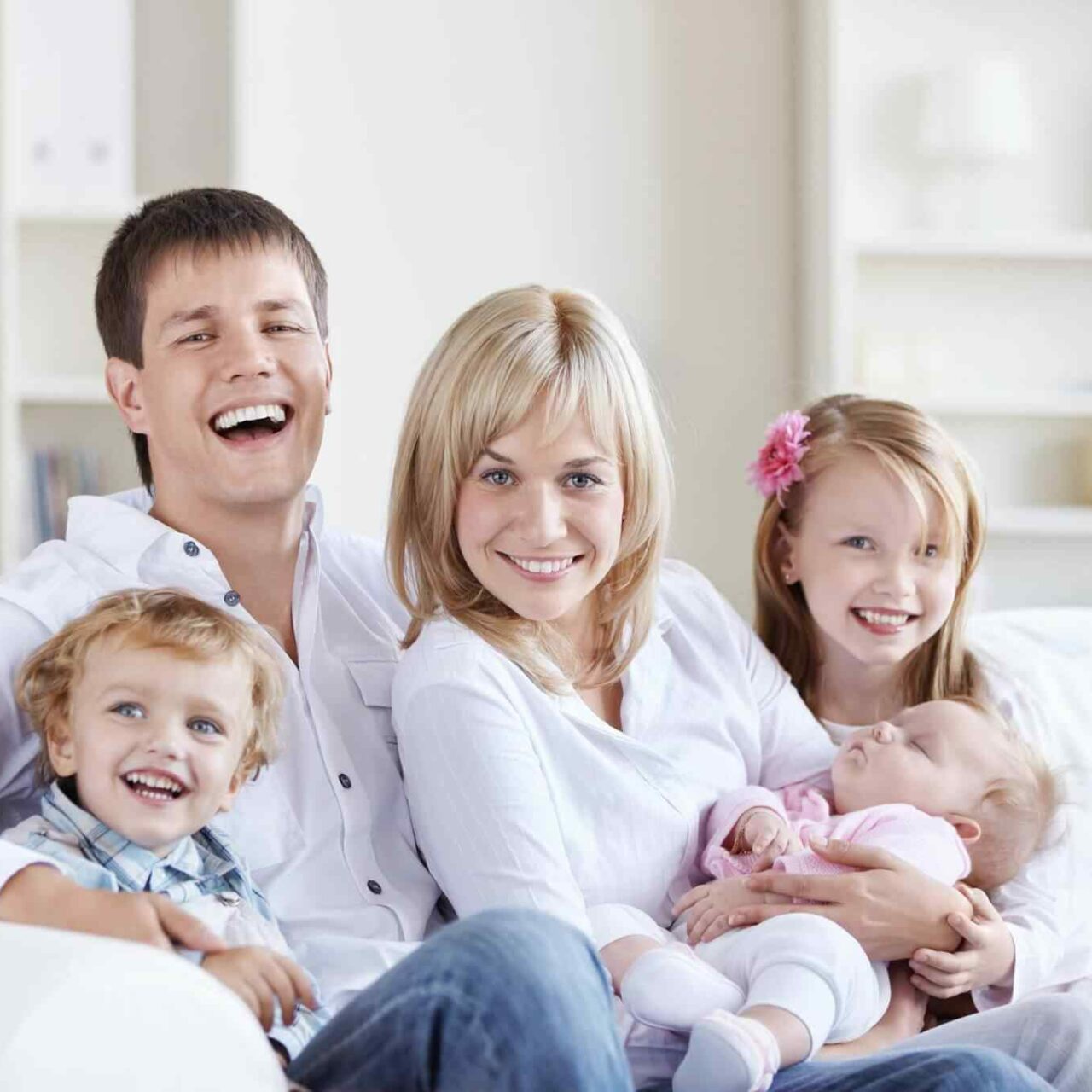 Happy family sitting together on sofa.