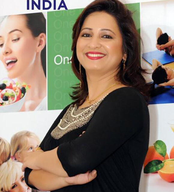 Smiling woman posing in front of banners.