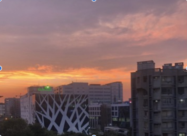 City skyline with colorful sunset sky.
